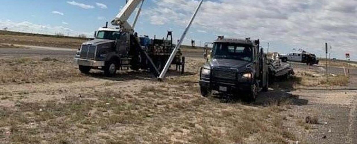 erecting light poles at SH 302 widening and improvements project